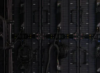 How Decentralized Is Ethereum? The 2026 Scorecard A modest home workspace with a laptop and external hard drives representing a decentralized Ethereum node runner's setup